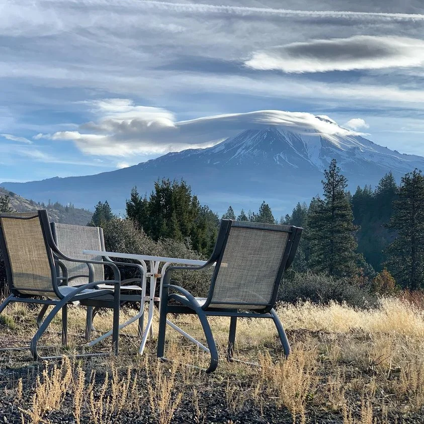 hilltop with table and chairs and Mount Shasta in the distance